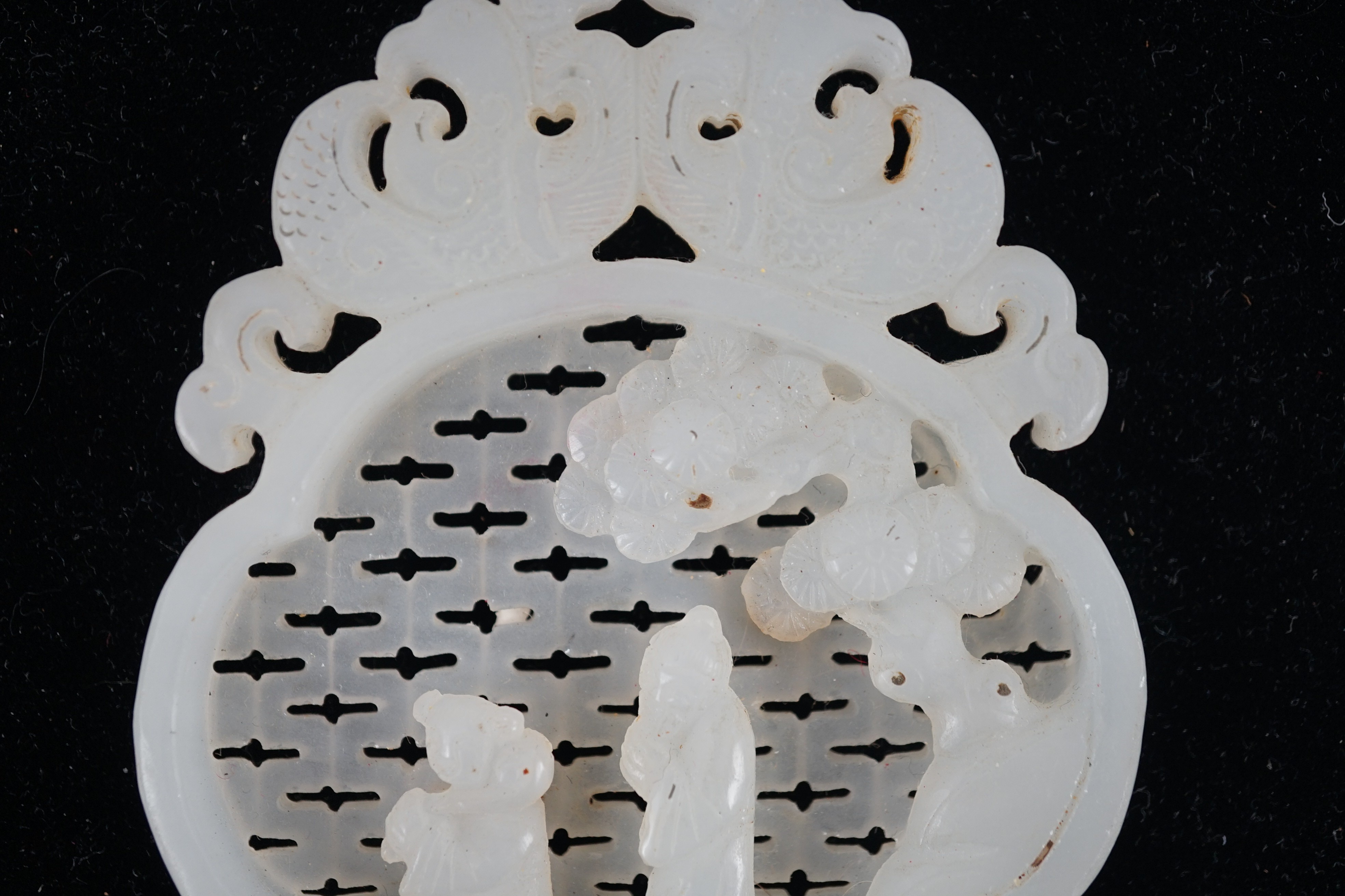 A Chinese white jade reticulated plaque, 19th century, 10.2cm high